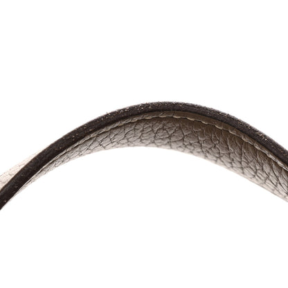Taupe calfskin leather handle edge detail with dark leather binding