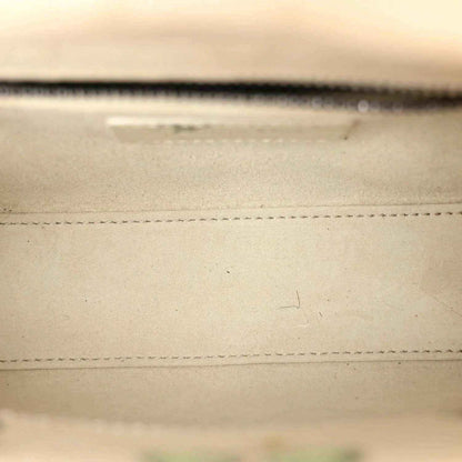 Mini Lady Dior bag close-up of stitched leather seam in white