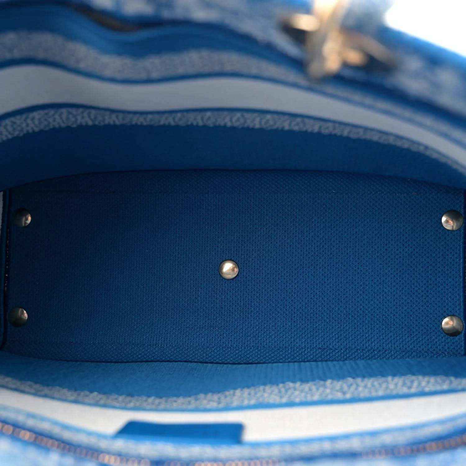 Blue fabric interior lining with metal snap button details inside the bag.