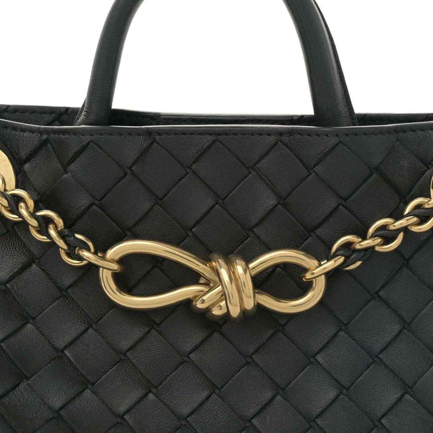 Black intrecciato leather bag front with gold-tone chain strap and oval knot clasp