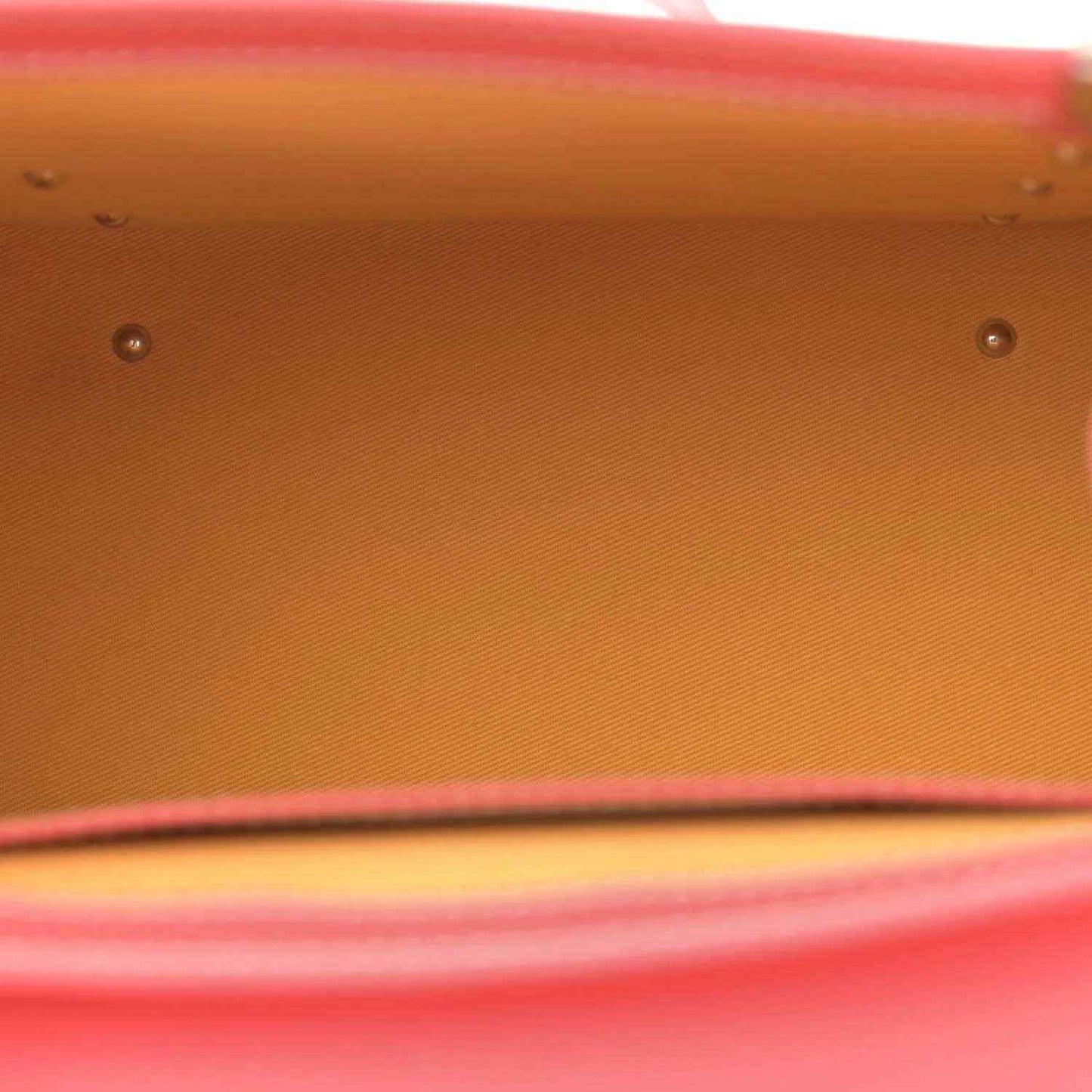 Pink canvas bag base with metal studs and a stitched edge detail.
