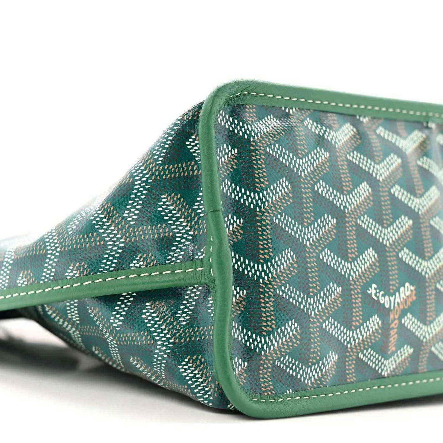 Reversible mini tote bag side panel with green Goyardine pattern and stitched trim