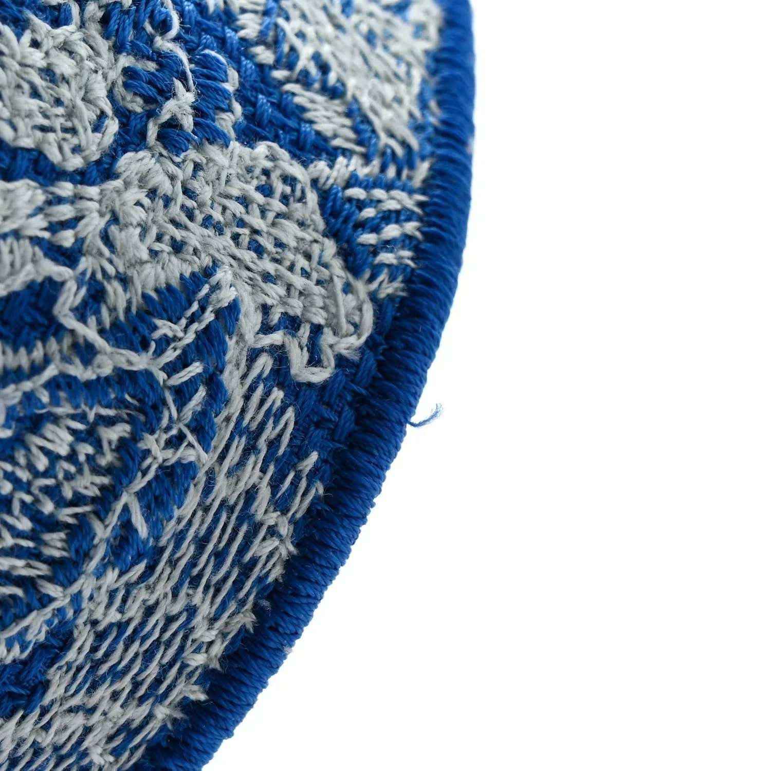 Blue-and-white toile bag corner with textured embroidery and blue piping