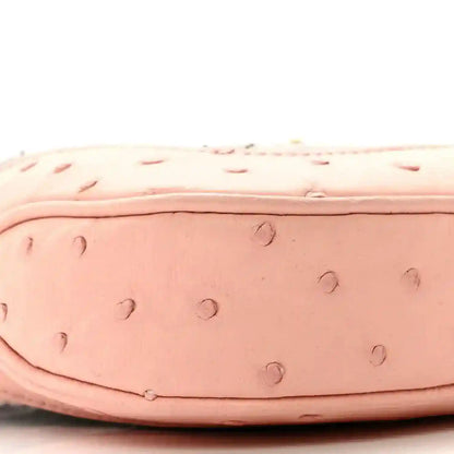 Gucci small hobo bag side close-up of pale pink ostrich-style texture