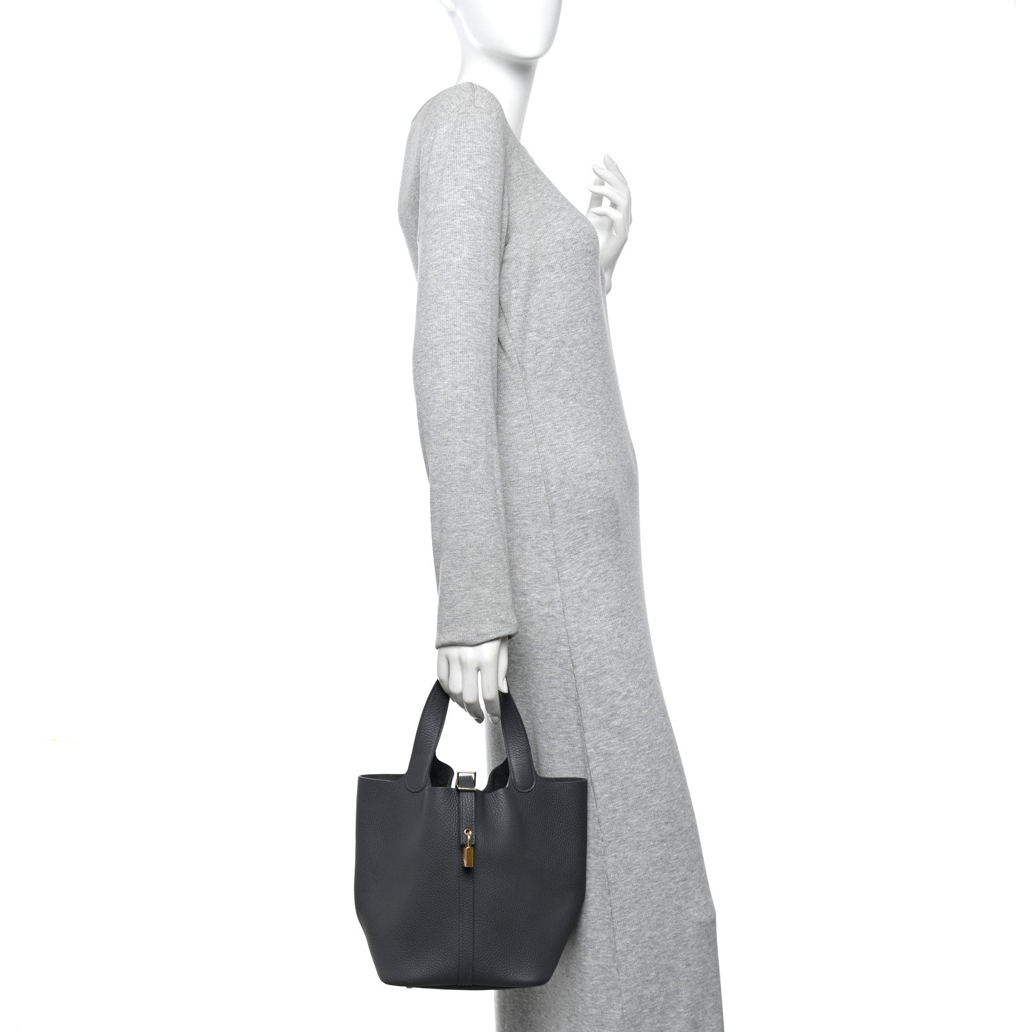 Leather tote bag in dark gray with top handle and slim shoulder strap on display