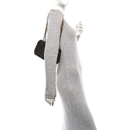 Dark shearling shoulder bag with gold chain strap, side profile