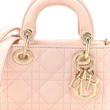 Pink quilted leather mini handbag front with gold rings and dangling Dior charm