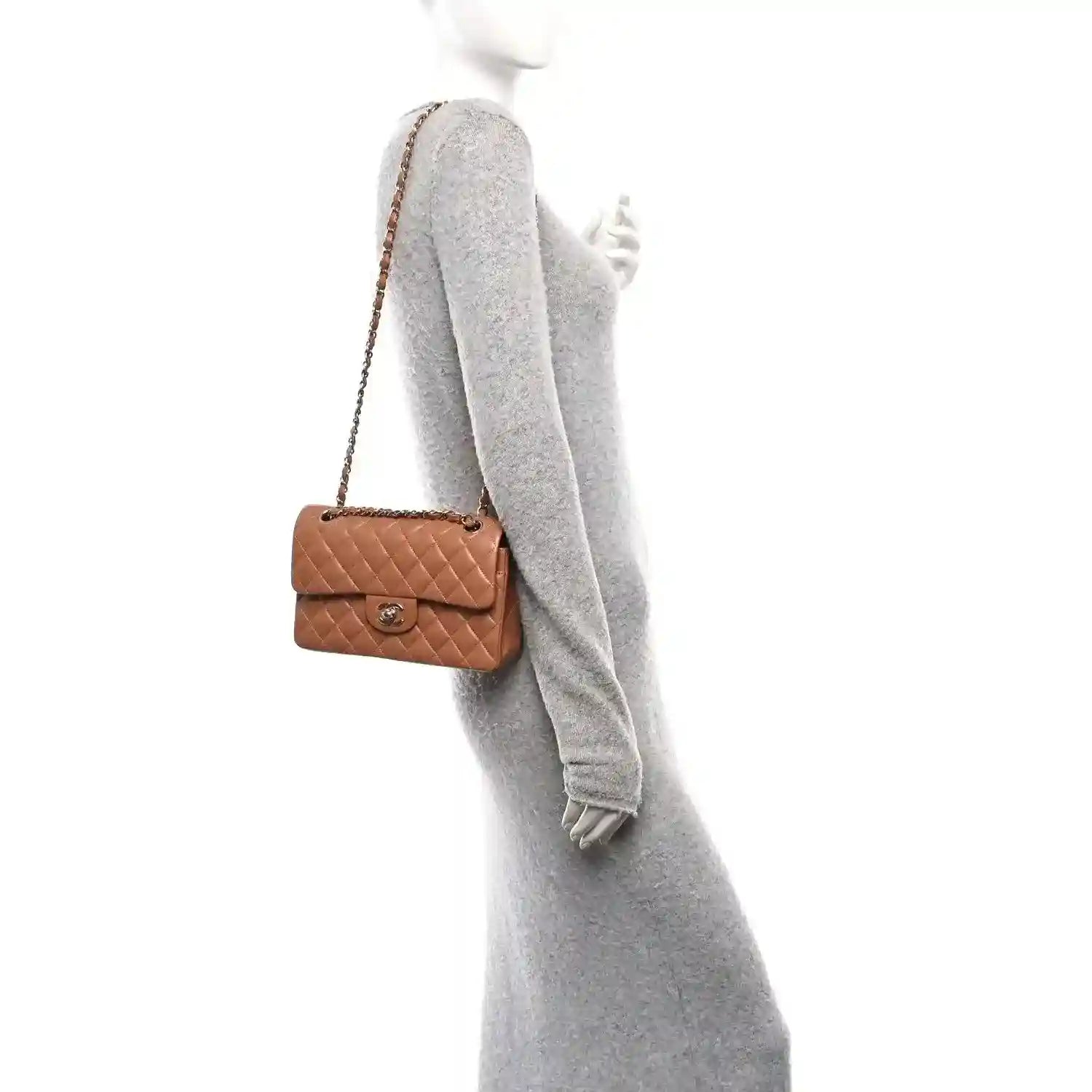 Brown quilted shoulder bag with chain strap worn crossbody; small flap with CC clasp.