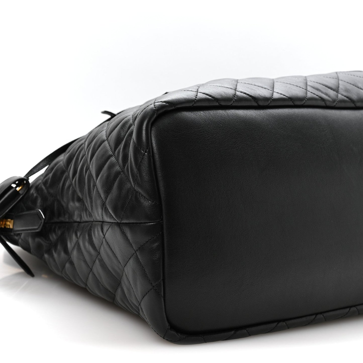 Black quilted leather travel bag with smooth end panel and shoulder strap