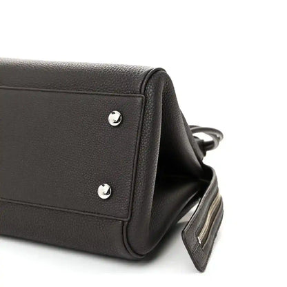 Dark leather Loewe Madrid bag side with silver studs and adjustable strap