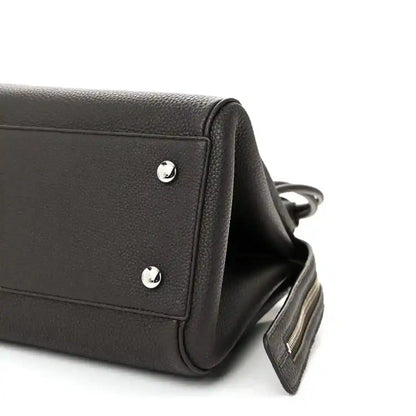 Dark leather Loewe Madrid bag side with silver studs and adjustable strap