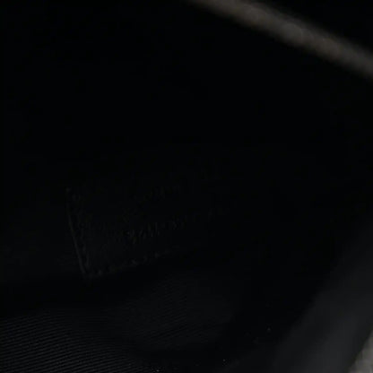Black satchel interior lining with subtle texture and stitched pocket seam
