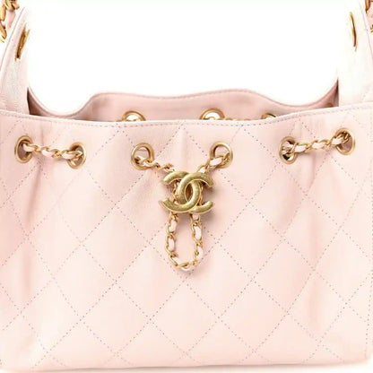 Light pink Chanel mini quilted leather handbag front with chain and dangling clasp