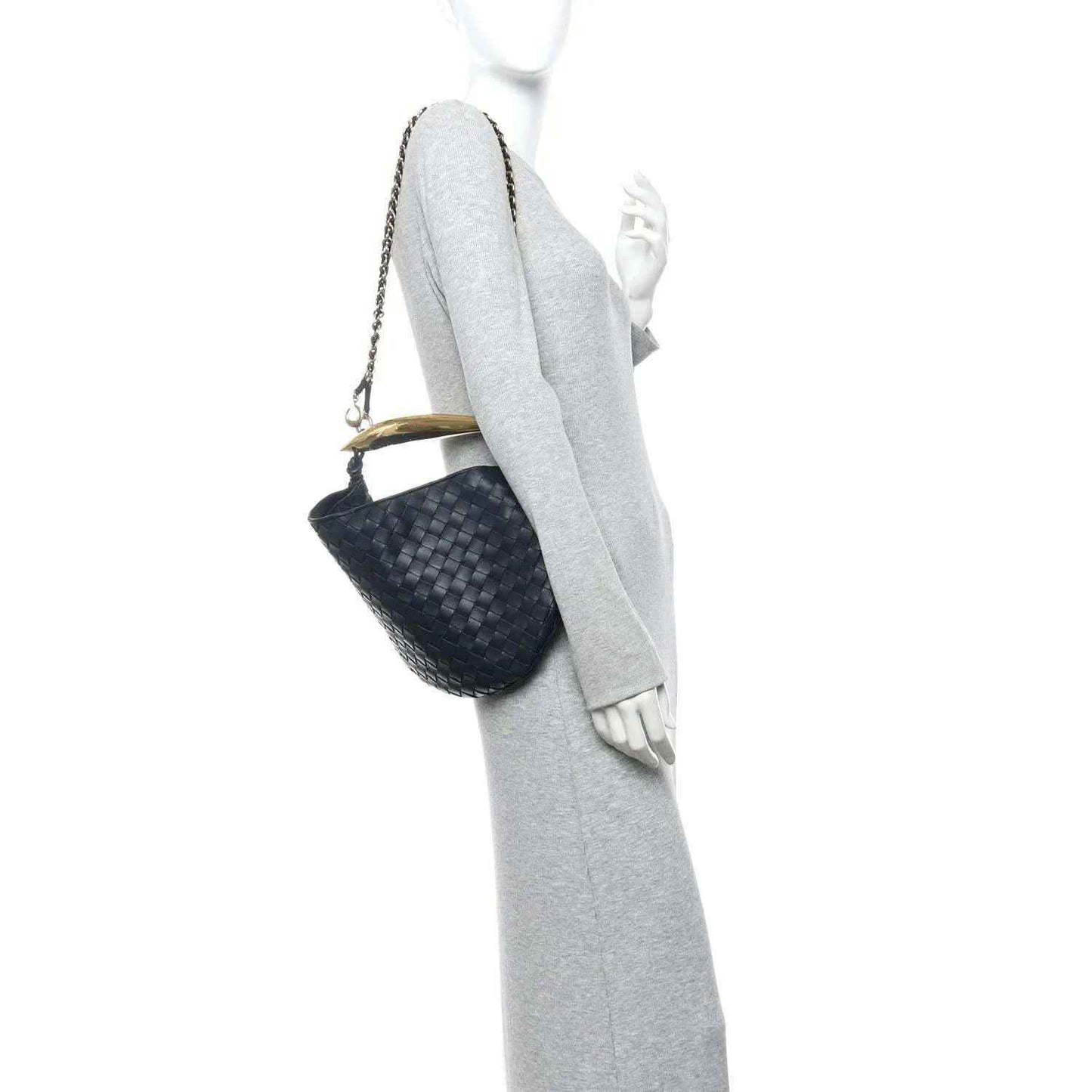 Black woven leather hobo bag with gold chain shoulder strap, shown on a mannequin