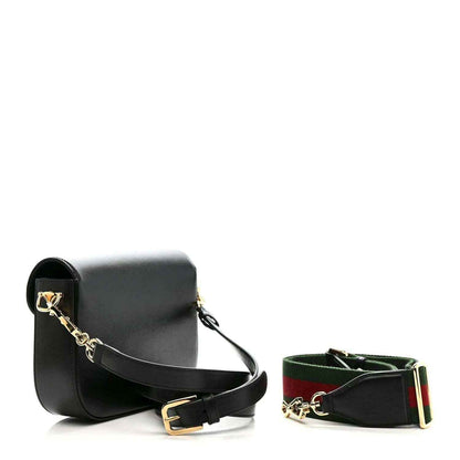 Black mini shoulder bag with gold horsebit and matching green-red web strap, plus belt