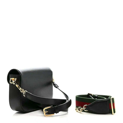 Black mini shoulder bag with gold horsebit and matching green-red web strap, plus belt