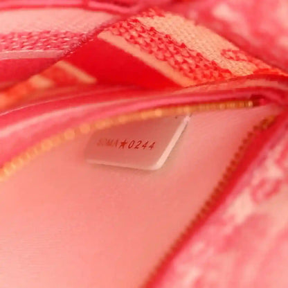 Inside tag on pink bag lining near zipper