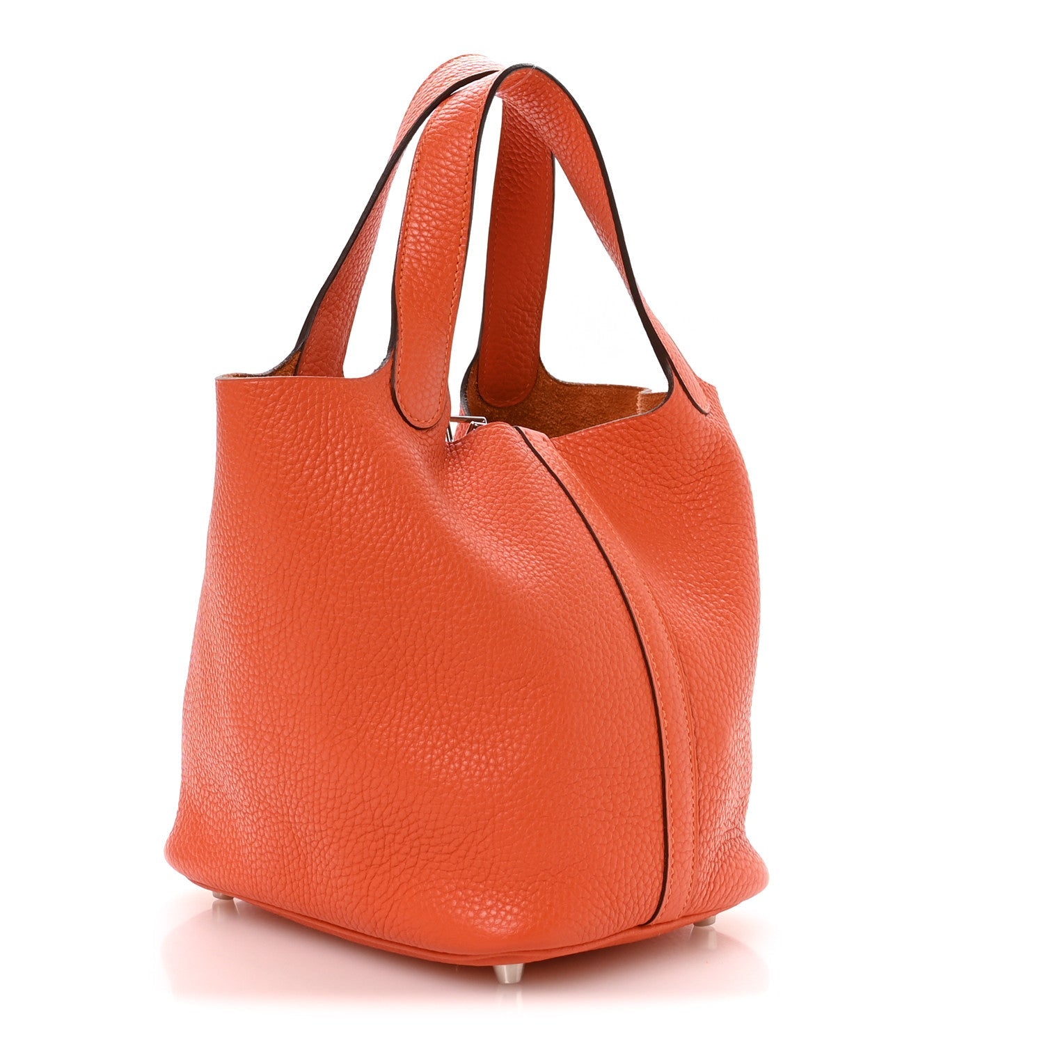 Orange pebbled leather handbag with top handles and curved side panel