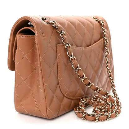 Small double flap shoulder bag detail: quilted brown leather, silver-tone chain, CC emblem.
