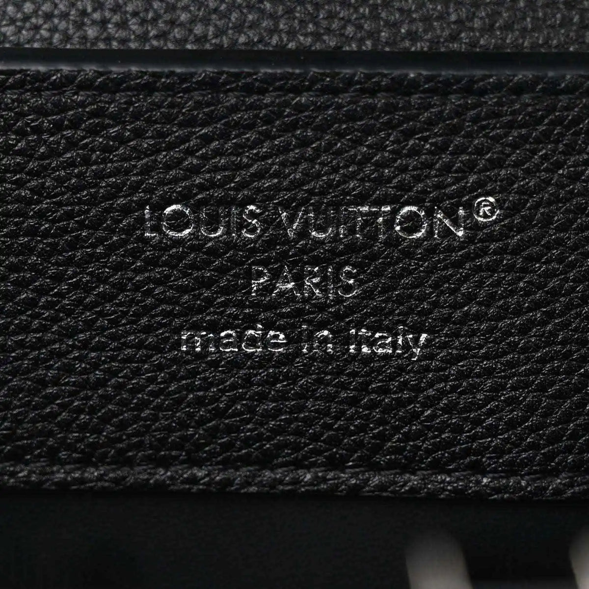 Black leather handbag with embossed Louis Vuitton Paris stamp and made in Italy text