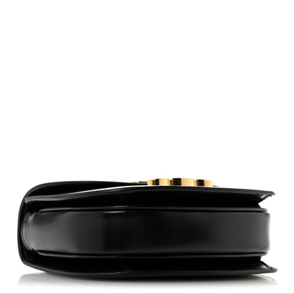 Black mini crossbody bag, side view with smooth leather and gold-tone edge detail