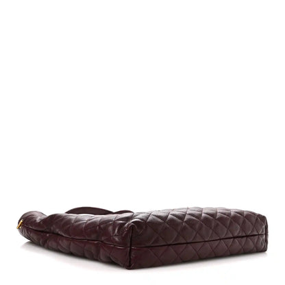 Quilted lambskin tote with flat base and single front zip pocket