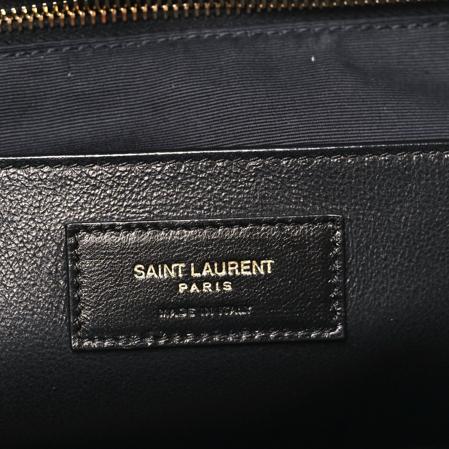 Saint Laurent Paris logo label on black lambskin lining near zipper