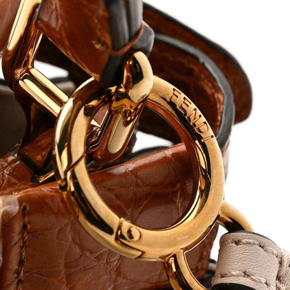 Mini Peekaboo satchel hardware detail with gold ring and brown crocodile strap