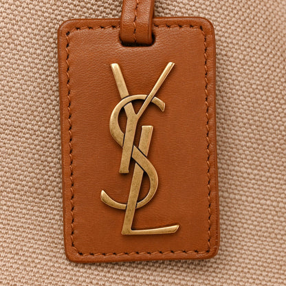 Leather-front tote tag with YSL gold logo and brown edge stitching