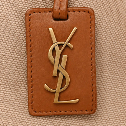 Leather-front tote tag with YSL gold logo and brown edge stitching