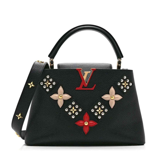 Black Louis Vuitton handbag with gold top handles and floral stud embellishments