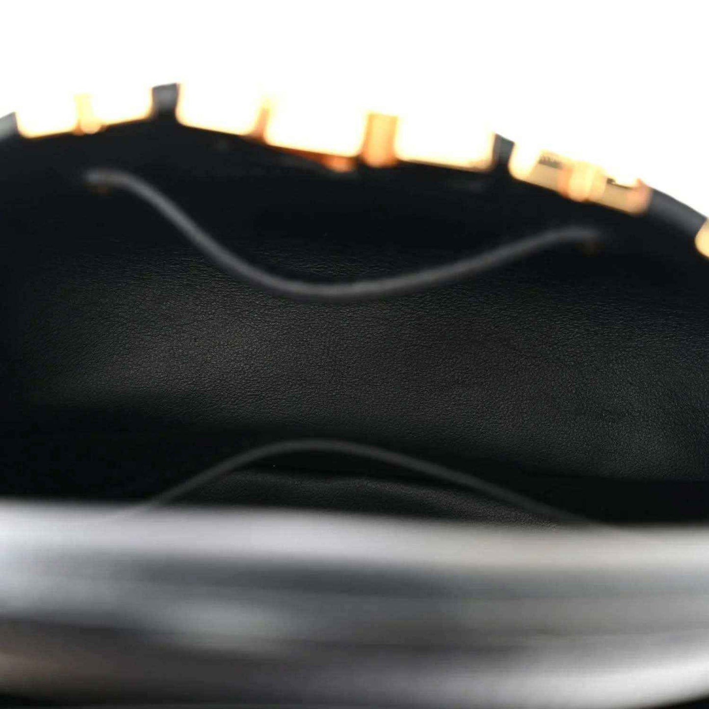 Black leather mini handbag interior panel with textured finish