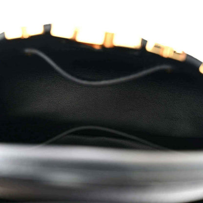 Black leather mini handbag interior panel with textured finish
