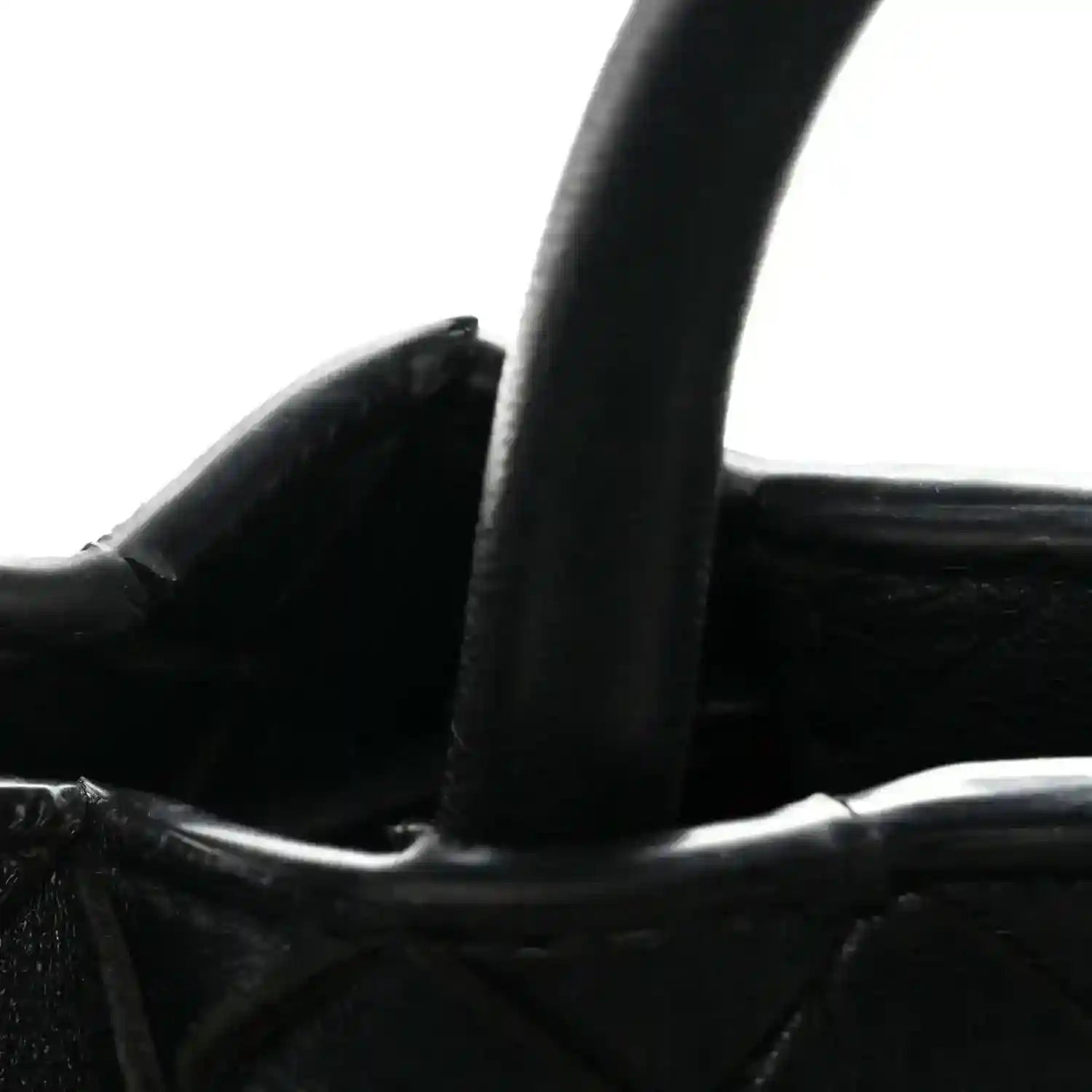 Black leather shoulder bag strap and braided top trim with interior view