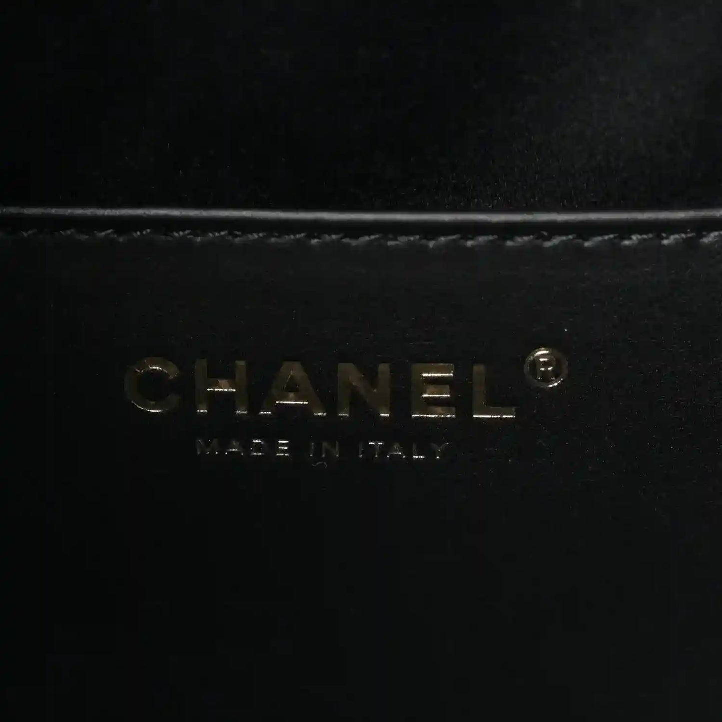CHANEL logo on black leather handbag lining
