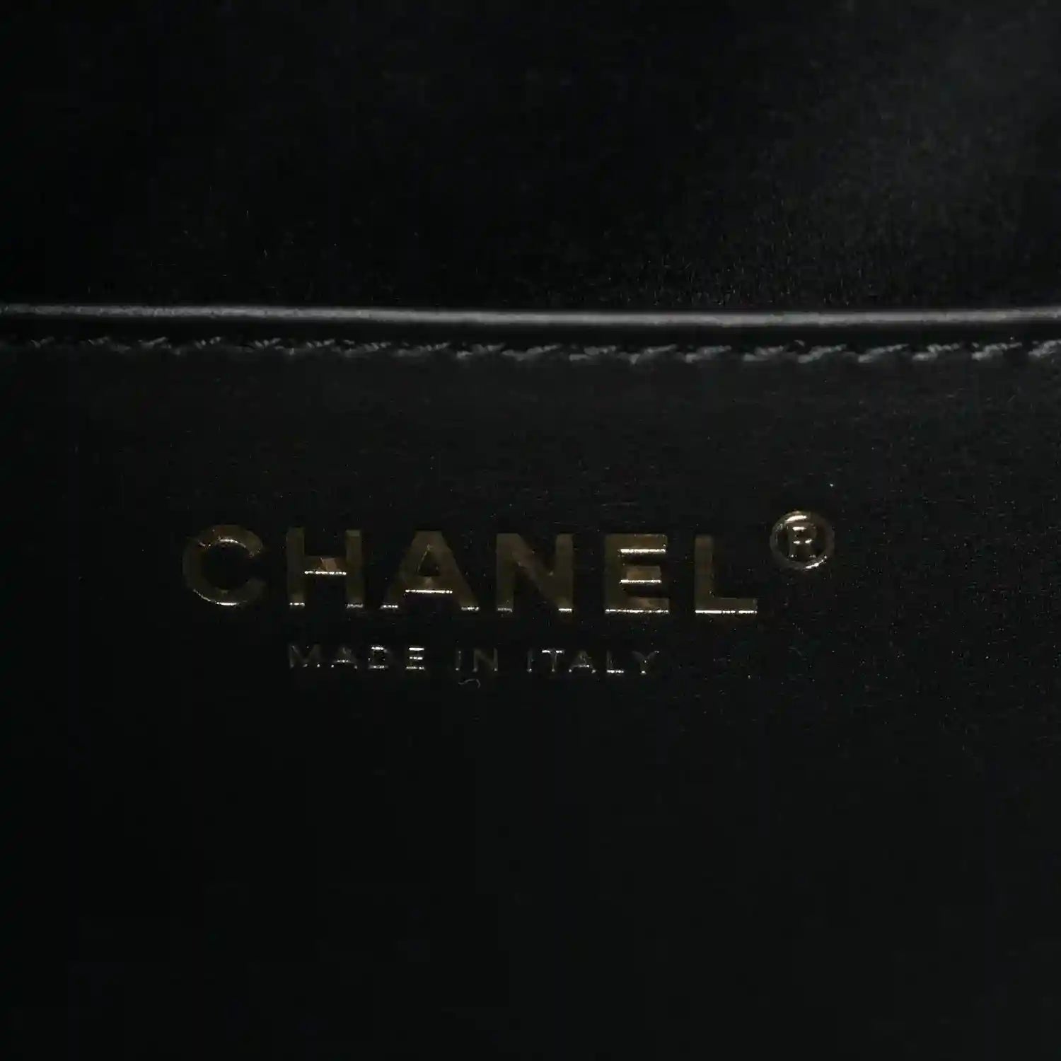 CHANEL logo on black leather handbag lining