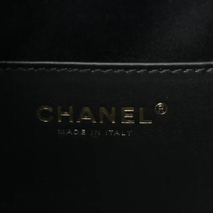 CHANEL logo on black leather handbag lining