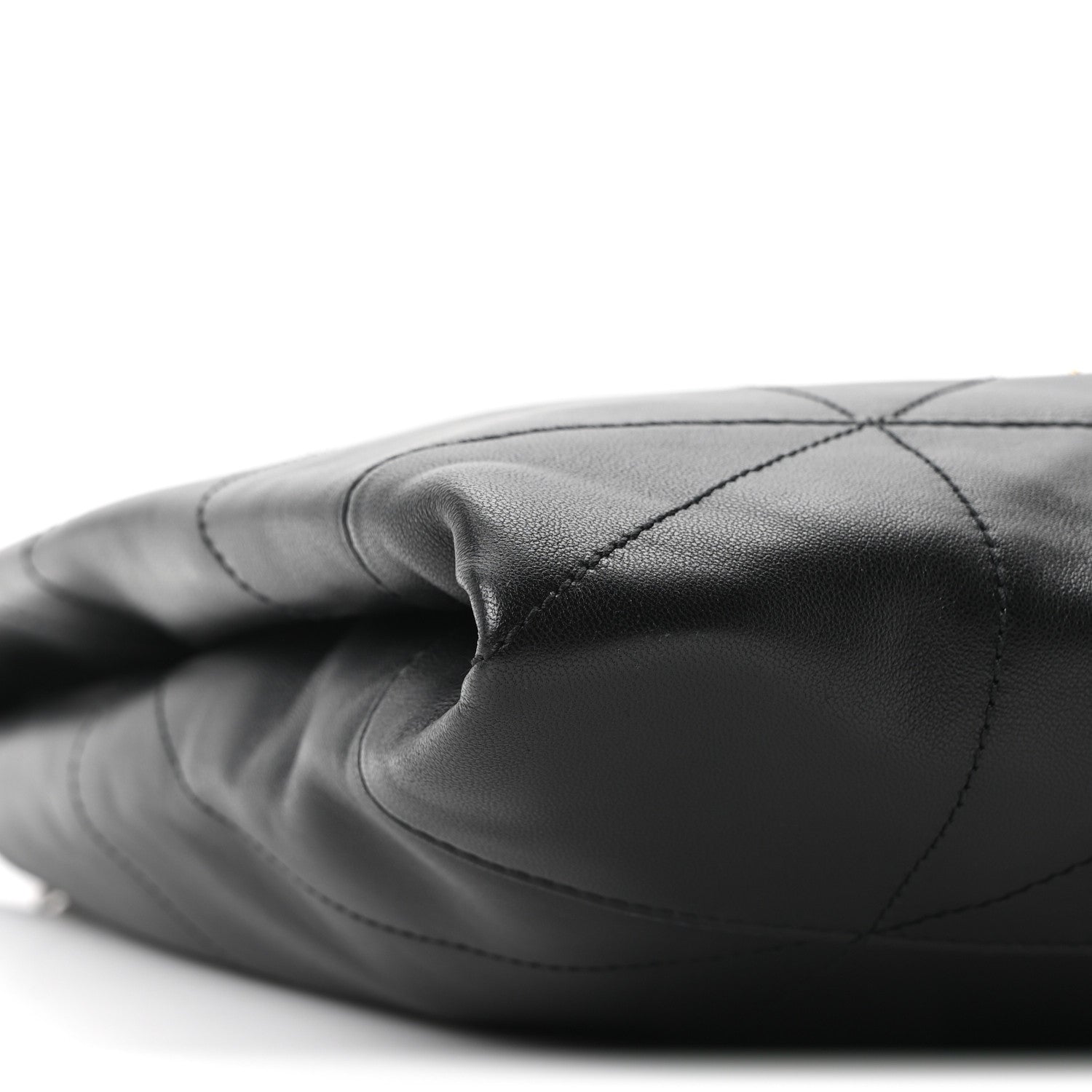 Black quilted leather bag side with stitched diamond panels