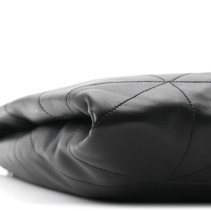 Black quilted leather bag side with stitched diamond panels