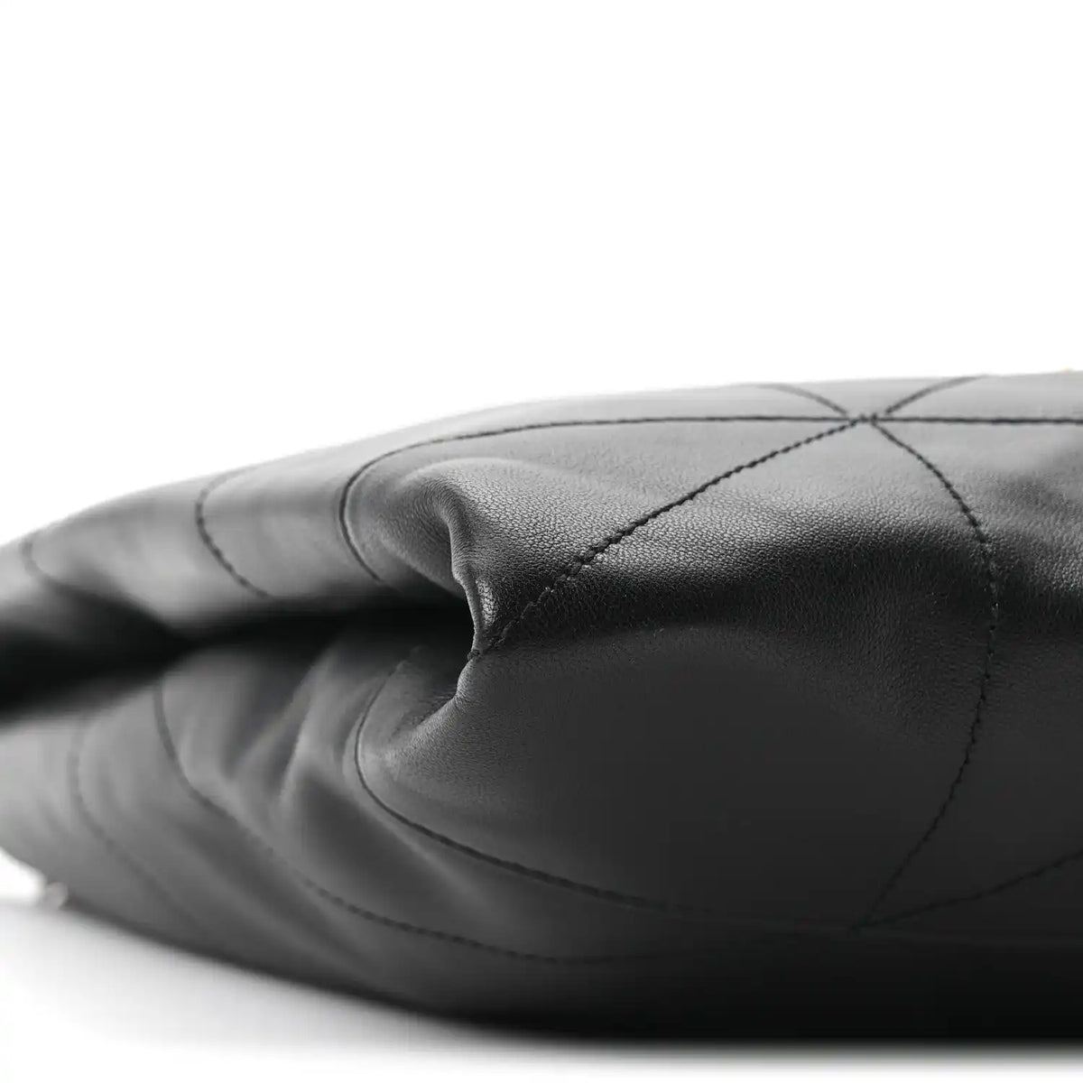 Black quilted leather bag side with stitched diamond panels