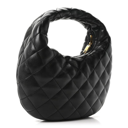 Quilted black leather hobo bag with top handle and gold side detail