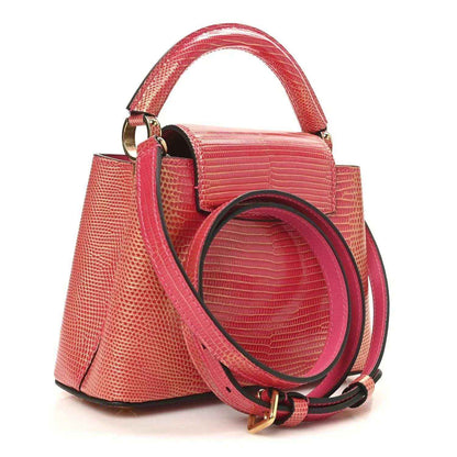 Louis Vuitton mini handbag, fuchsia textured lizard, shoulder strap and gold rings.