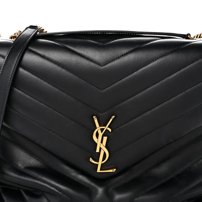 Black quilted satchel front with YSL logo plaque and leather flap