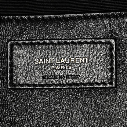 Black leather brand label reading SAINT LAURENT PARIS and MADE IN ITALY