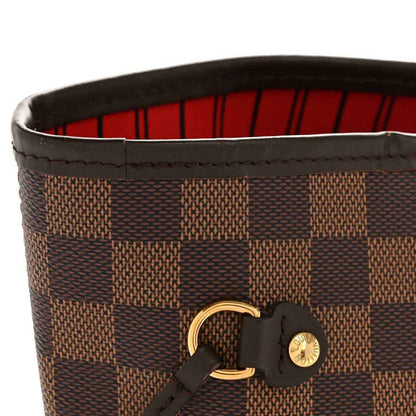 Damier Ebene tote bag top edge with red lining and black leather strap with gold hardware