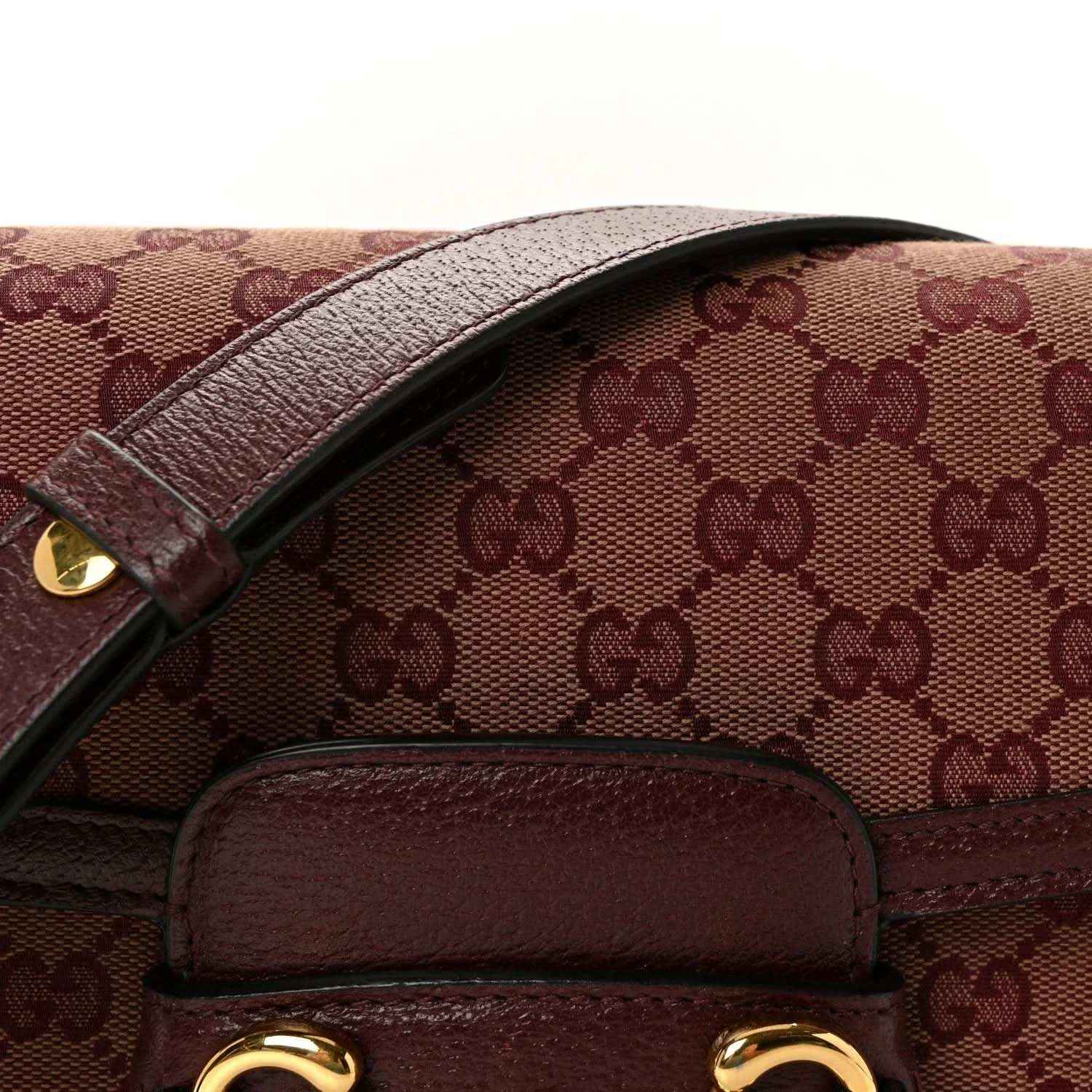 Gucci horsebit shoulder bag close-up of monogram canvas flap and burgundy leather trim