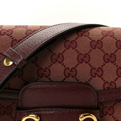 Gucci horsebit shoulder bag close-up of monogram canvas flap and burgundy leather trim