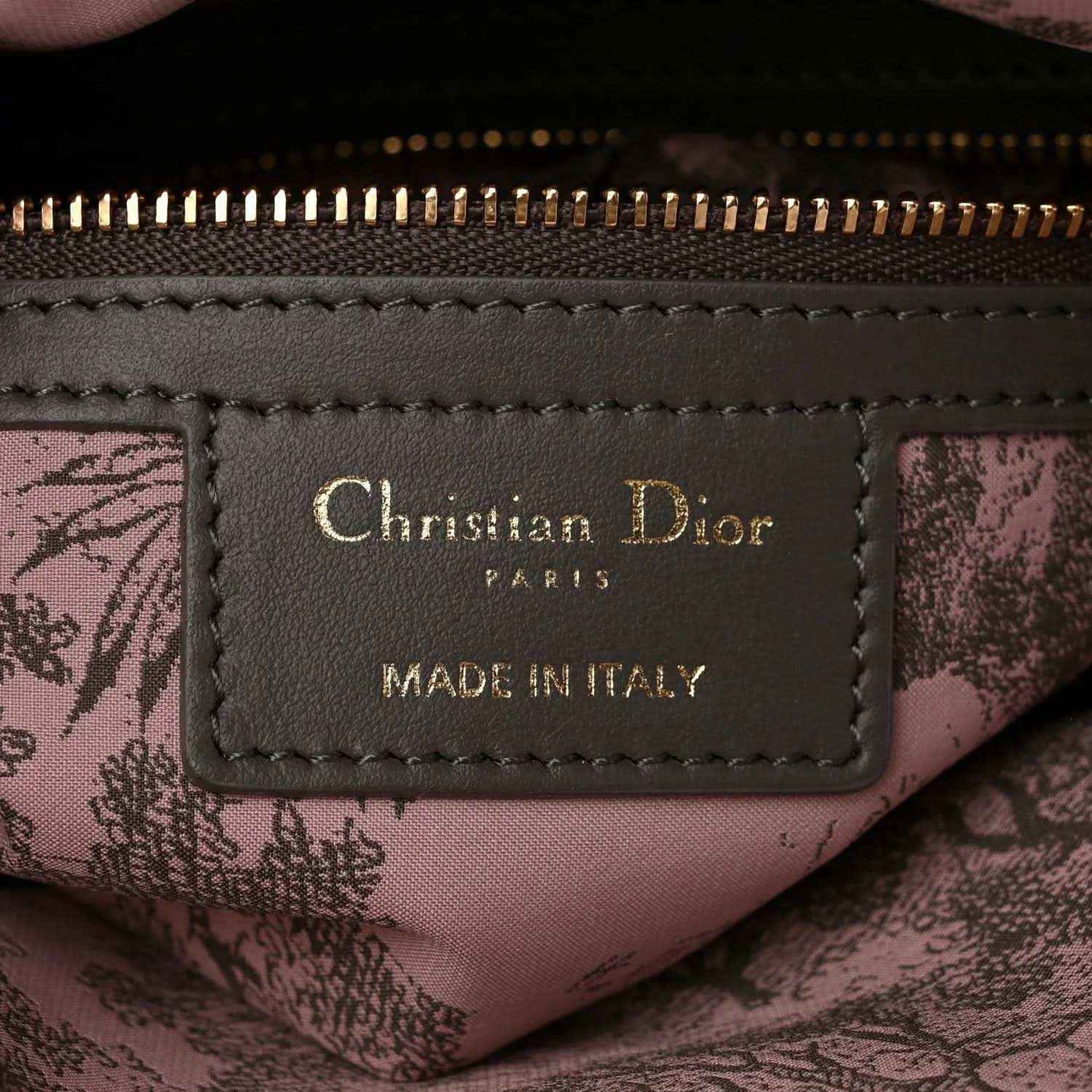Leather brand label inside bag reading Christian Dior Paris Made in Italy