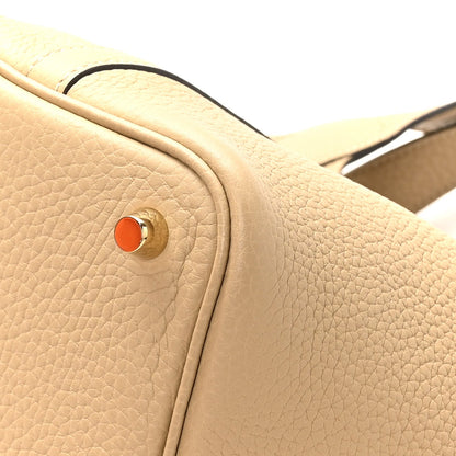 Beige leather tote side snap button hardware with orange center rivet