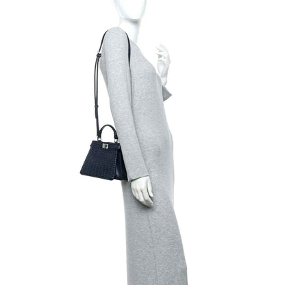 Midnight blue leather petite satchel with woven texture, short strap and long crossbody strap